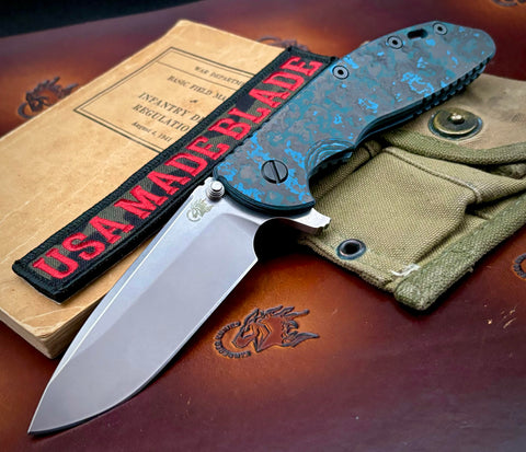 Specialty Hinderer XM-24 Spearpoint Battle Blue Ti Arctic Storm Fat Carbon Fiber with S45VN SW Blade Black HW Holey Clip