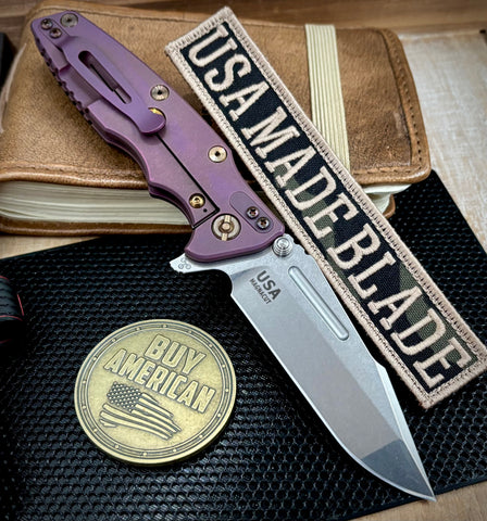 High Res Battle Purple Hinderer Eklipse 3.5" Skinny Fullered Harpoon Spanto Black G10 Anodized Working Finish Ti Stonewashed Magnacut Blade with bronzed out hardware
