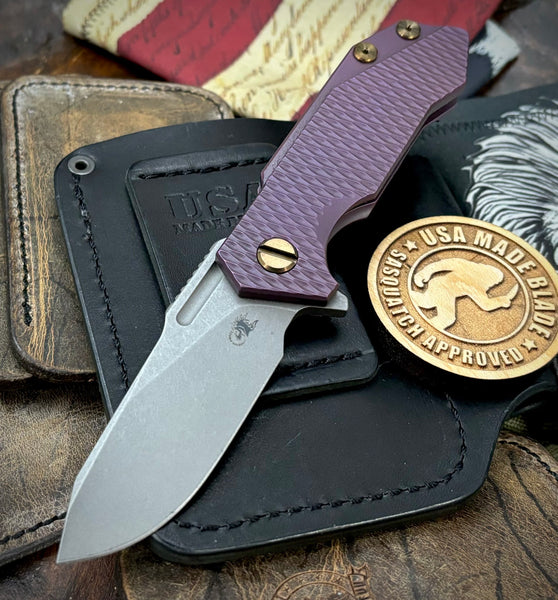 High Res Battle Purple Slicer Hinderer Half Track Gen 2 Anodized Textured Ti Presentation Side, Smooth Ti Lockside Magnacut Working Finish Blade Bronzed Out HW