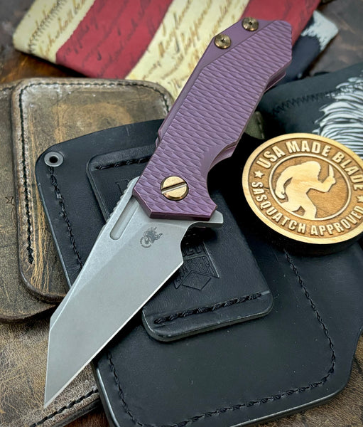 High Res Battle Purple Wharnie Hinderer Half Track Gen 2 Anodized Textured Ti Presentation Side, Smooth Ti Lockside Magnacut Working Finish Blade Bronzed Out HW