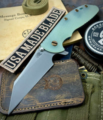 High Res Battle Green Hinderer XM-24 Skinny Wharncliffe Translucent Green G10 with S45VN Working Finish Blade Black Nitride and Bronzed Out Hardware Squatched