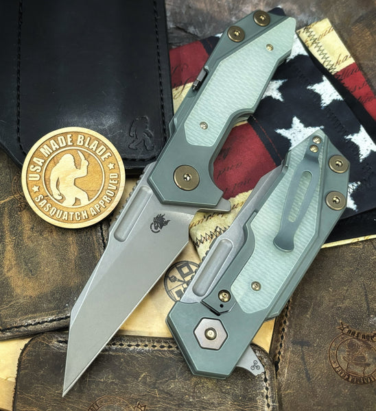 Ammo Can Green Hinderer Full Track Wharncliffe Anodized Working Finish Ti with Translucent Green G10 and Working Finish S45VN Blade and bronzed out hardware