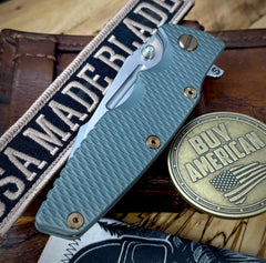 Ammo Can Green Hinderer Eklipse 3.5" Skinny Fullered Harpoon Spearpoint Textured Anodized Working Finish Ti Presentation Side, Smooth Lockside, and Stonewashed Magnacut Blade with bronzed out hardware