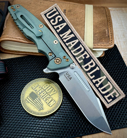 Ammo Can Green Hinderer Eklipse 3.5" Skinny Fullered Harpoon Spanto Blue/Black G10 Anodized Working Finish Ti Stonewashed Magnacut Blade with bronzed out hardware