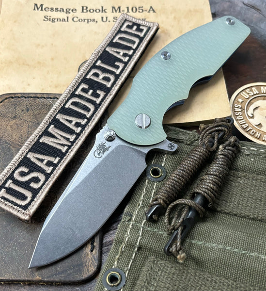 Hinderer Jurassic Hollow Ground Slicer Translucent Green G10 Blue Ti Magnacut Stonewashed Blade