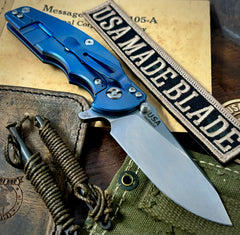 Hinderer Jurassic Hollow Ground Slicer OD Green G10 Blue Ti Magnacut Stonewashed Blade