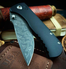 Defiant-7 Talos Button Lock with Black Boomerang Stainless Chad Nichols Damascus Blade and Black Hardcoat Anodized Aluminum Handles