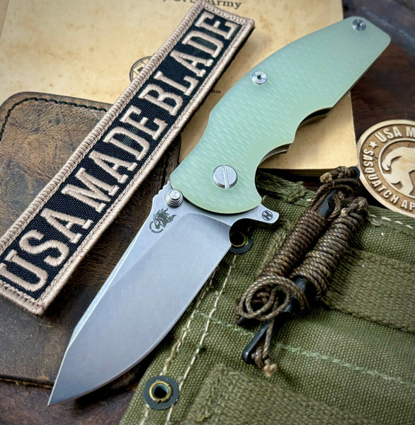 Hinderer Jurassic Hollow Ground Slicer Translucent Green G10 Bronze Ti Magnacut Stonewashed Blade