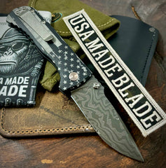 Battle Stars & Stripes Defiant-7 Talos Button Lock with Black Boomerang Stainless Chad Nichols Damascus Blade and Black Hardcoat Anodized Aluminum Handles