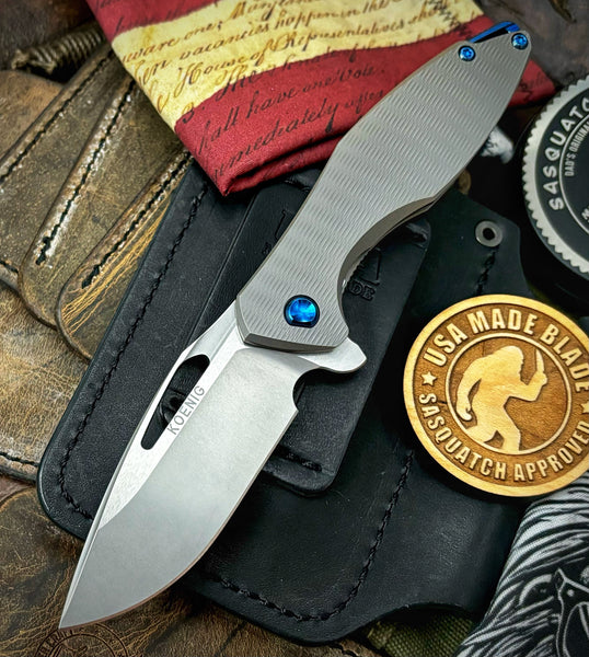 Koenig Mini Arius with M390 Burnished Blade with Polished Flats Plexa Ti and Blue Ti Hardware