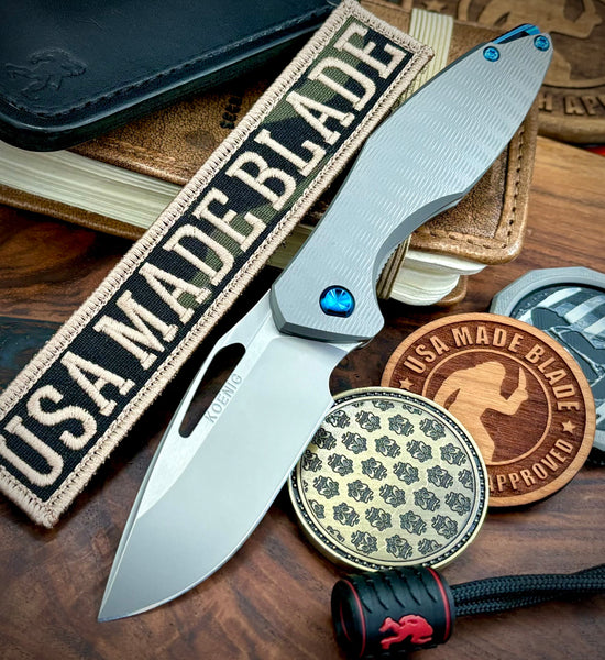 Non Flipper Koenig Mini Arius with M390 Burnished Blade with Polished Flats Plexa Ti and Blue Ti Hardware  MA21511221P