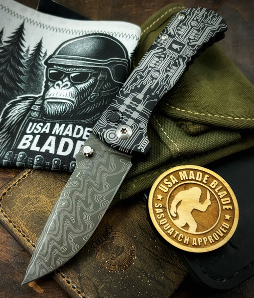 Circuit Squatch Defiant-7 Talos Button Lock with Black Boomerang Stainless Chad Nichols Damascus Blade and Black Hardcoat Anodized Aluminum Handles