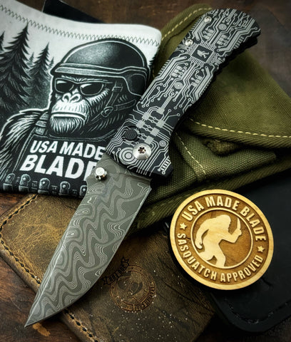 Circuit Squatch Defiant-7 Talos Button Lock with Black Boomerang Stainless Chad Nichols Damascus Blade and Black Hardcoat Anodized Aluminum Handles
