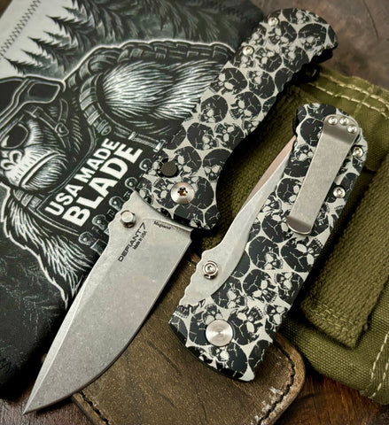 Defiant-7 Talos Button Lock Skull Patterned Handles with Magnacut Blade and Black Hardcoat Anodized Aluminum Handles