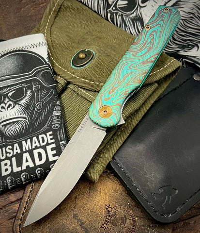 Toxic Anomascus Rockwall Flipper with Magnacut Blade Countoured Ti Handles with bronze ti hardware from Tactile Knife Co.