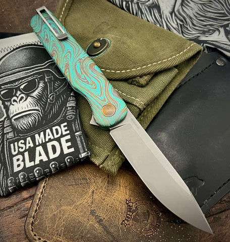 Toxic Anomascus Rockwall Flipper with Magnacut Blade Countoured Ti Handles with bronze ti hardware from Tactile Knife Co.
