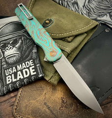 Toxic Anomascus Rockwall Flipper with Magnacut Blade Countoured Ti Handles with bronze ti hardware from Tactile Knife Co.